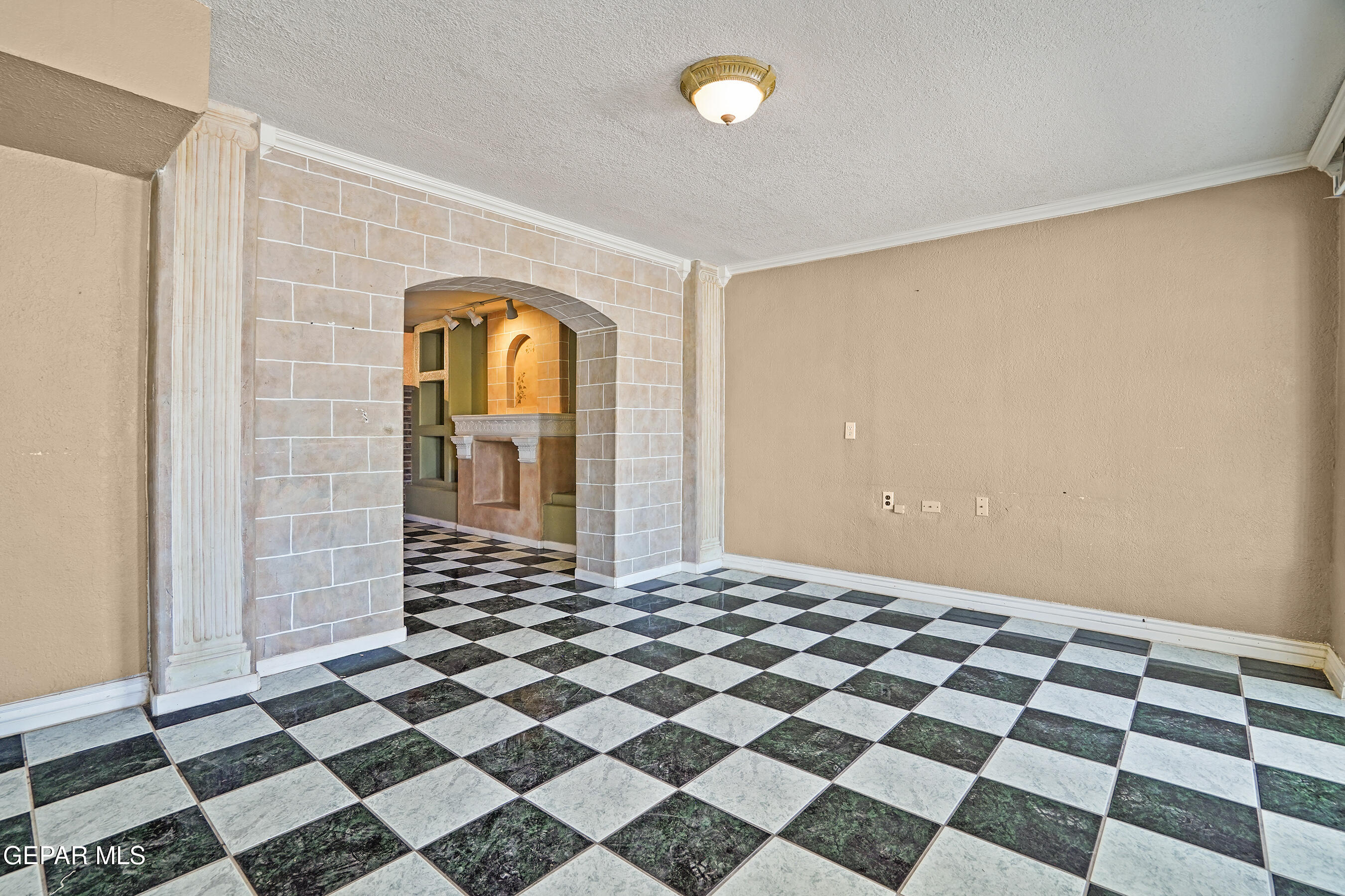 306 A Street Southwest Fabens, TX 79838 - Photo 3 of 37 a bedroom with a black and white checkered floor