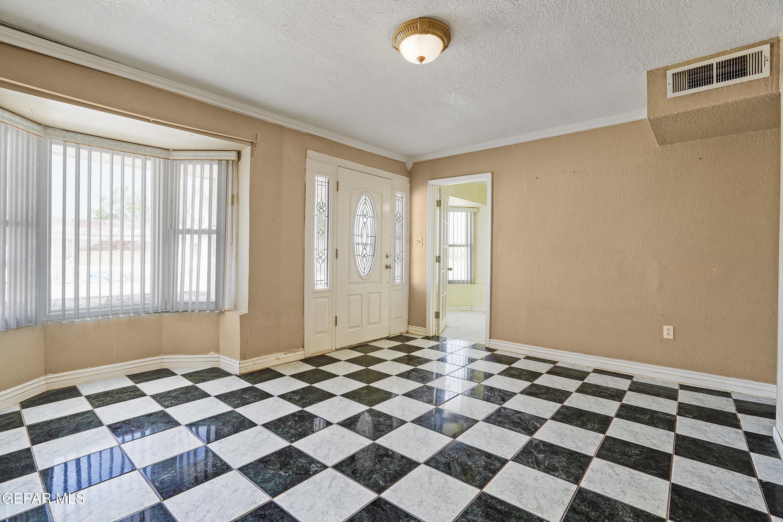 306 A Street Southwest Fabens, TX 79838 - Photo 4 of 37 a view of a livingroom with a black and white checkered floor