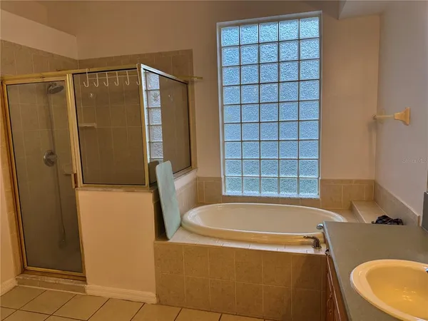 a bathroom with a tub and a shower