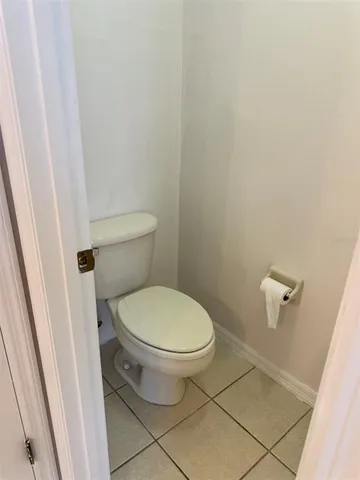 a white toilet sitting next to a shower