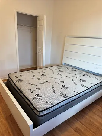 a bed with white cabinets