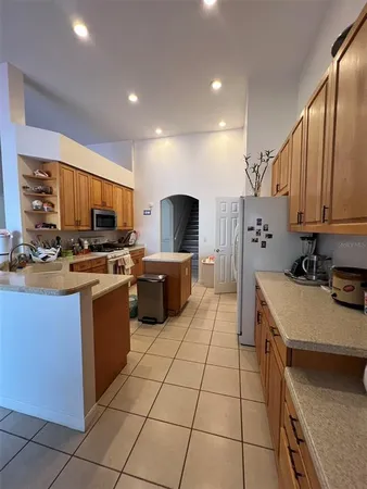 a kitchen with a sink a counter top space appliances and cabinets