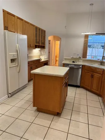 a kitchen with stainless steel appliances granite countertop a refrigerator sink and cabinets