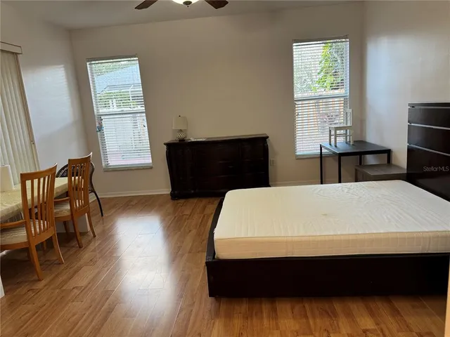 a living room with a bed furniture and a window