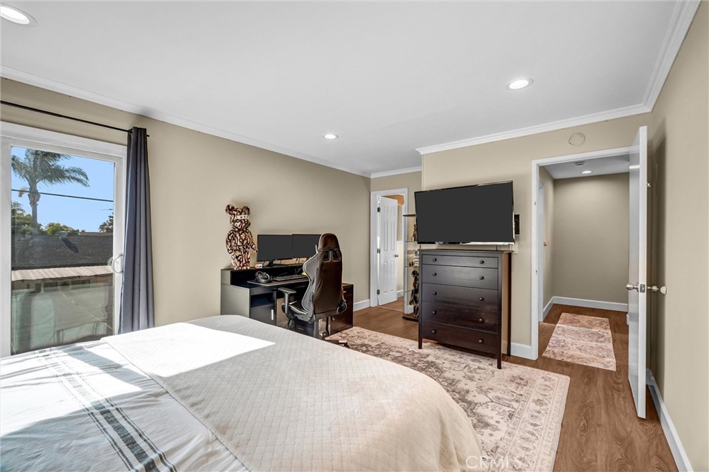 10661 Ritter Street Cypress, CA 90630 - Photo 21 of 32 upstairs primary bedroom with sunset views from sliding door and access to sun deck