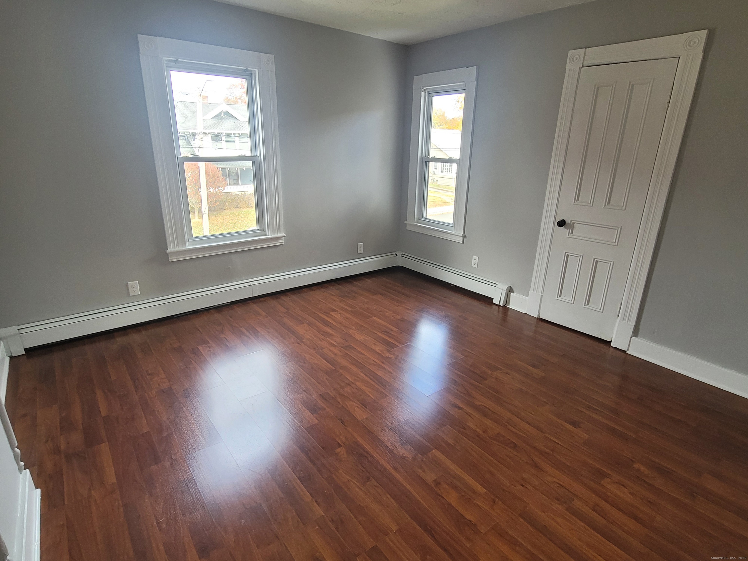 36 5th Street, Unit A Norwalk, CT 06855 - Photo 11 of 15 an empty room with wooden floor and windows