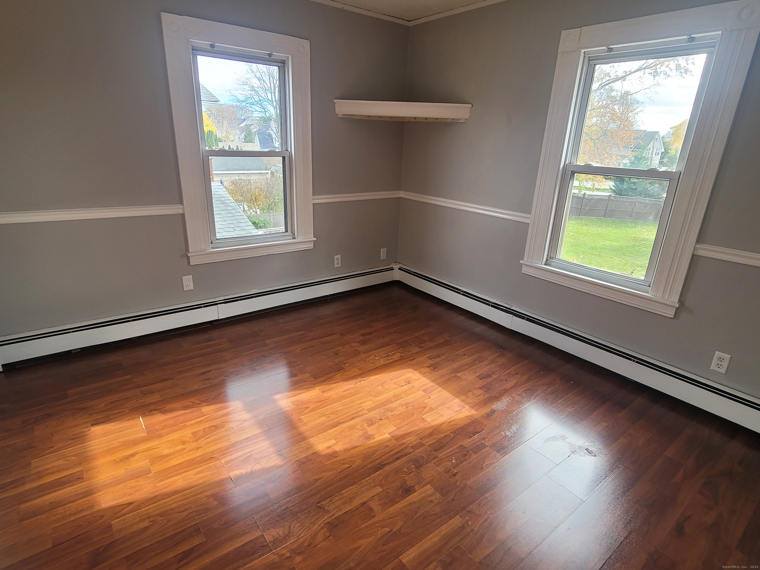 36 5th Street, Unit A Norwalk, CT 06855 - Photo 12 of 15 an empty room with wooden floor and windows