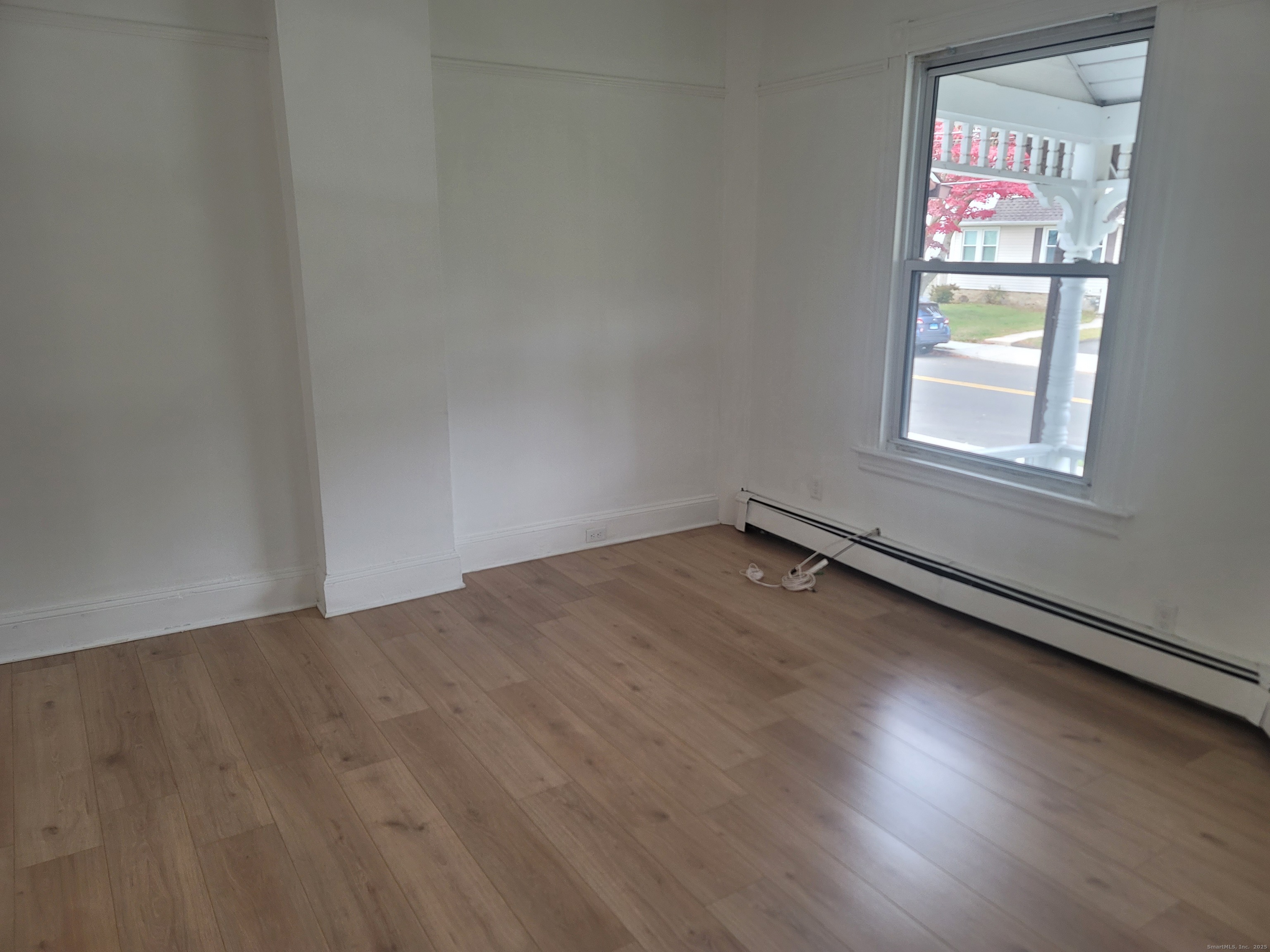 36 5th Street, Unit A Norwalk, CT 06855 - Photo 4 of 15 an empty room with wooden floor and windows