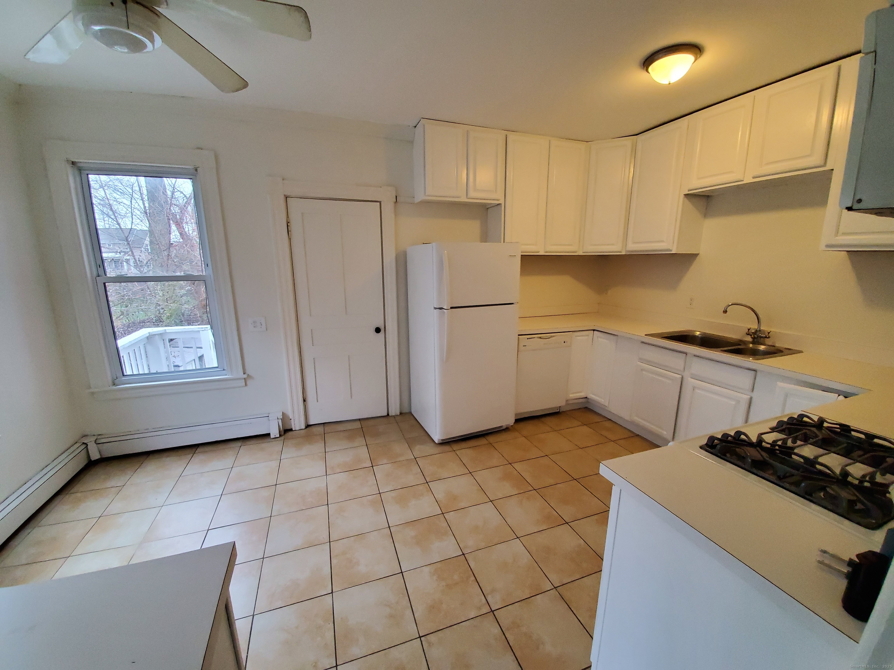 36 5th Street, Unit A Norwalk, CT 06855 - Photo 6 of 15 a kitchen with a stove a sink and a refrigerator