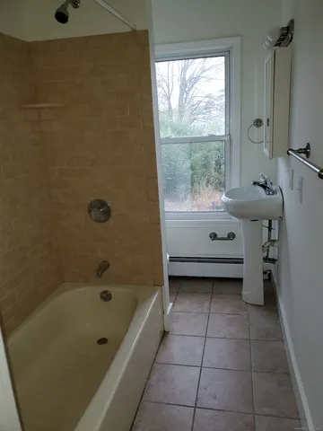 a bathroom with a tub toilet and sink
