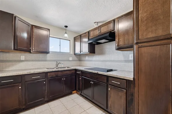 a kitchen with stainless steel appliances granite countertop a sink and a stove