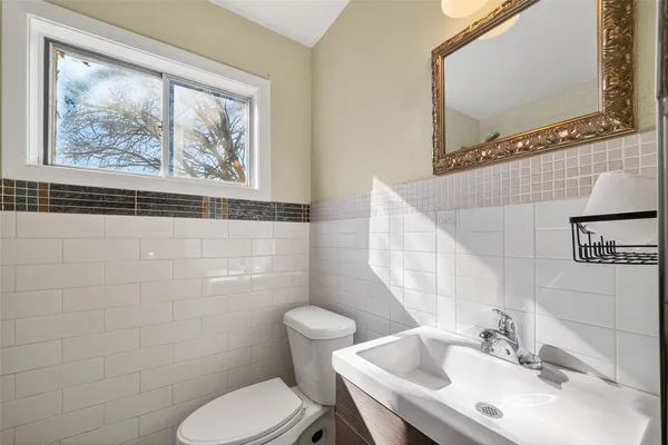 a bathroom with a toilet a sink and mirror
