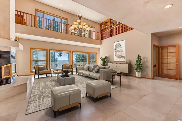 a living room with furniture and a chandelier