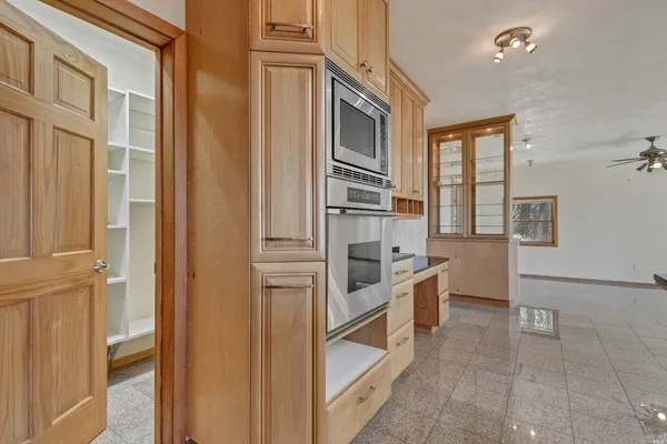 a kitchen with stainless steel appliances granite countertop a refrigerator and a stove