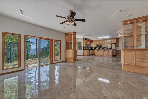 a view of a livingroom with furniture window and a kitchen