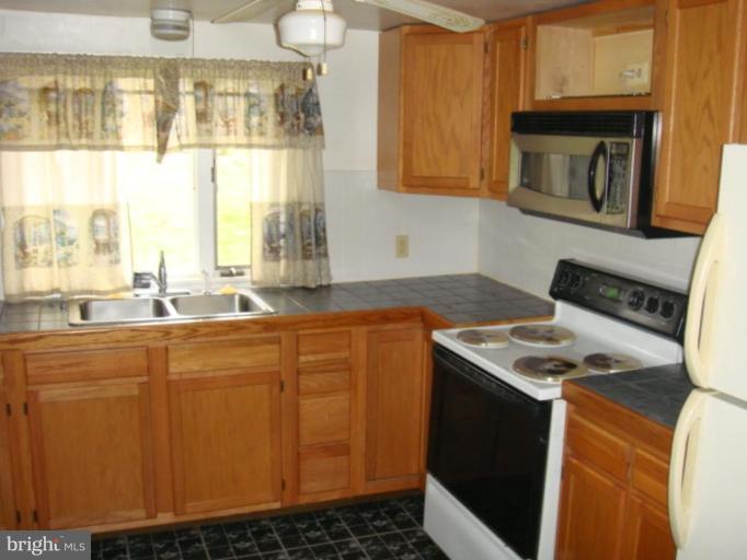 407 Lee Street Ranson, WV 25438 - Photo 5 of 6 a kitchen with stainless steel appliances granite countertop a sink stove and cabinets