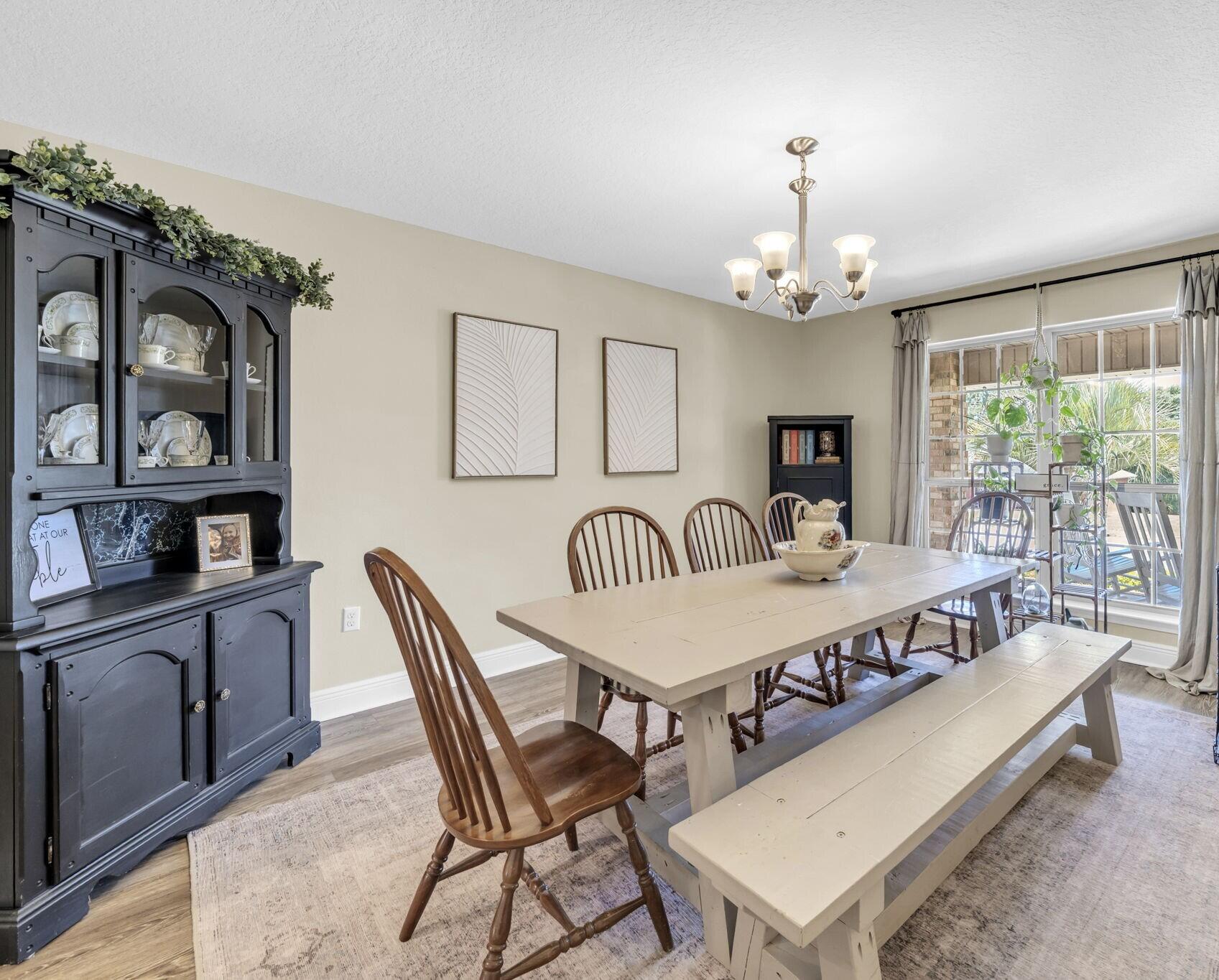 217 Raptor Drive Crestview, FL 32536 - Photo 15 of 48 a large dining space with furniture window and wooden floor