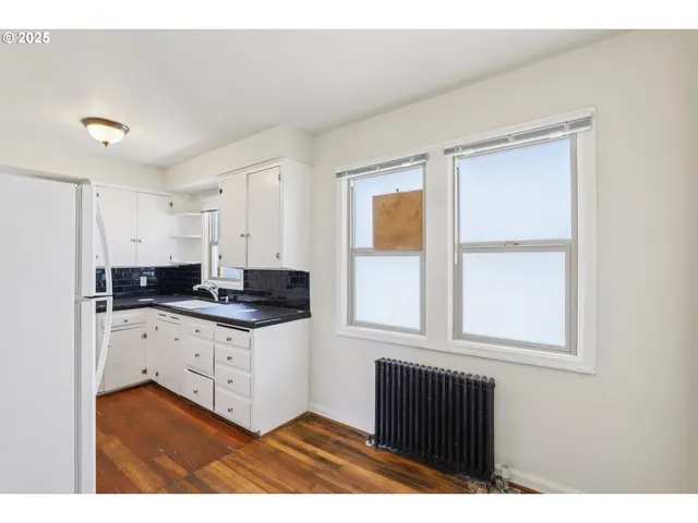 a kitchen with a sink cabinets and a window