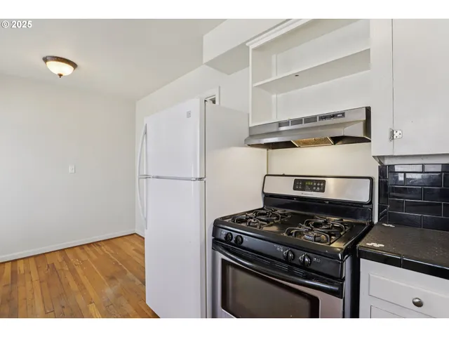 a kitchen with a stove and a refrigerator