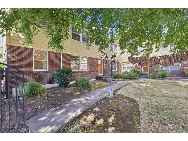 a view of a street with a house in the background