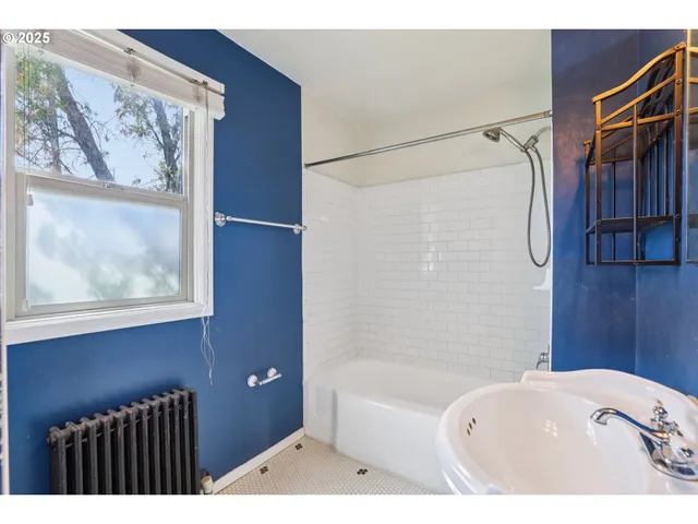 a bathroom with a bathtub and a shower