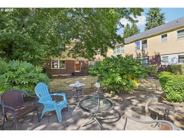 a backyard of a house with table and chairs