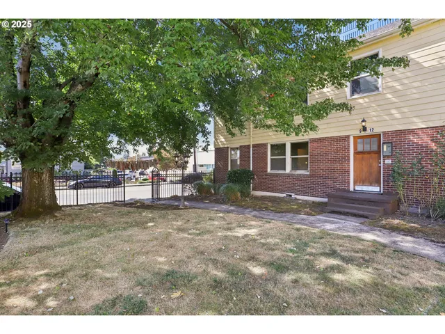 a view of a yard with a house and a tree