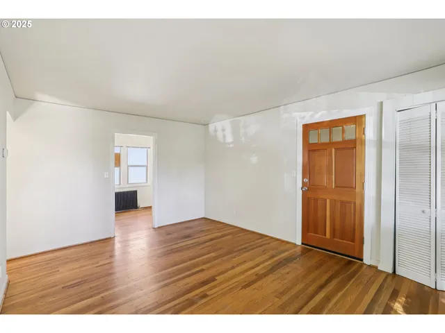 a view of an empty room and wooden floor