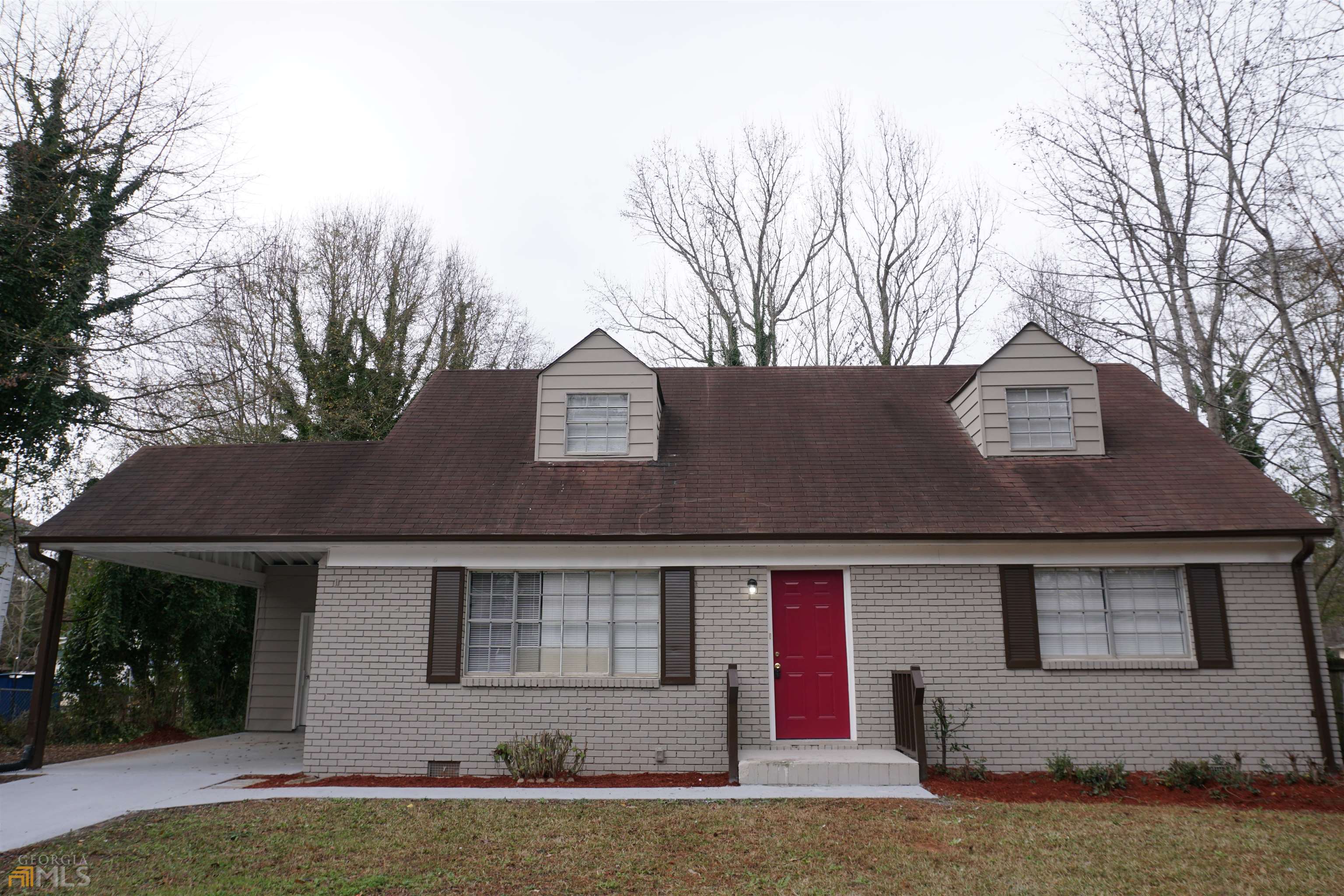 10733 Brant Street Hampton, GA 30228 - Photo 1 of 1 a front view of a house with a yard and garage