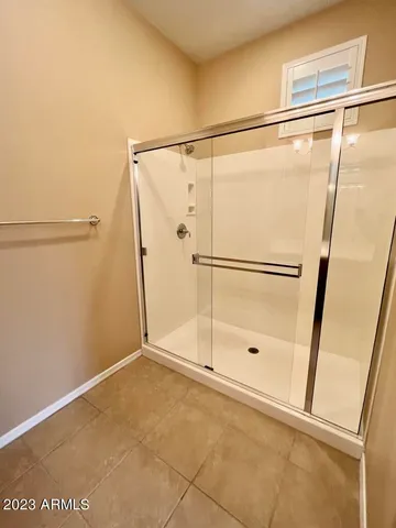 a bathroom with a glass shower door