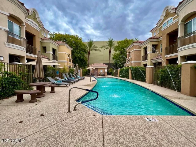 a view of a building with garden and sitting area