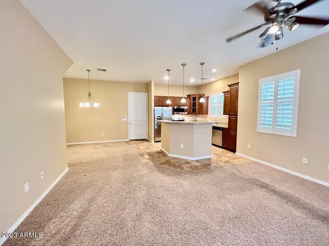 a view of a kitchen with a sink and a refrigerator