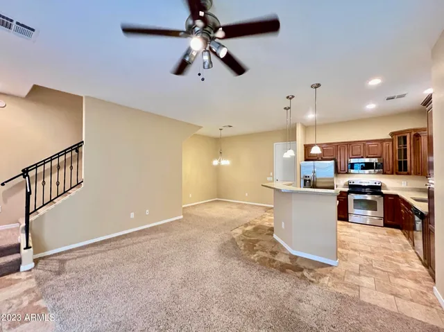 a view of kitchen with microwave and cabinets