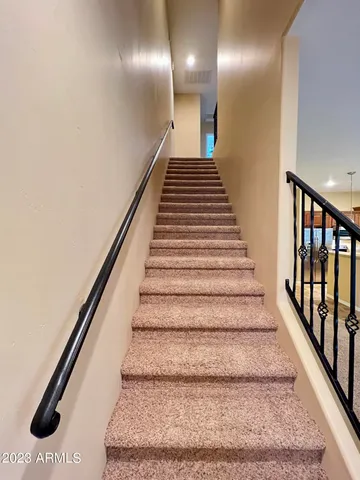 a view of staircase with lots of frames on wall