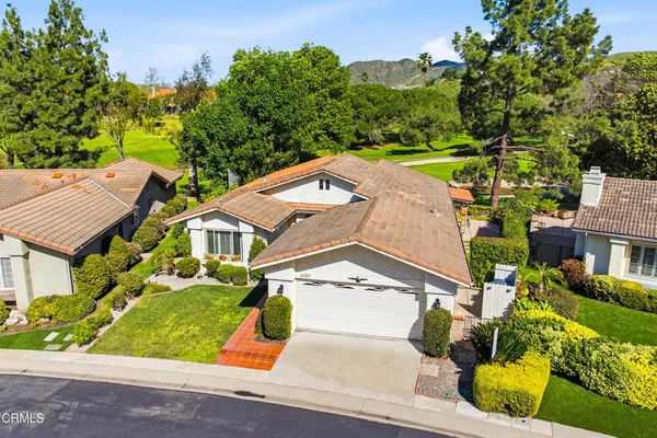 an aerial view of a house with a garden and trees