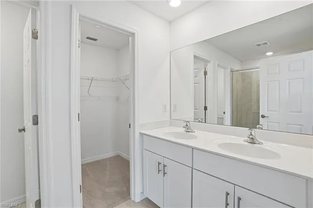 an empty room with closet and ceiling fan