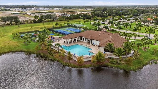 an aerial view of a house with a garden and lake view