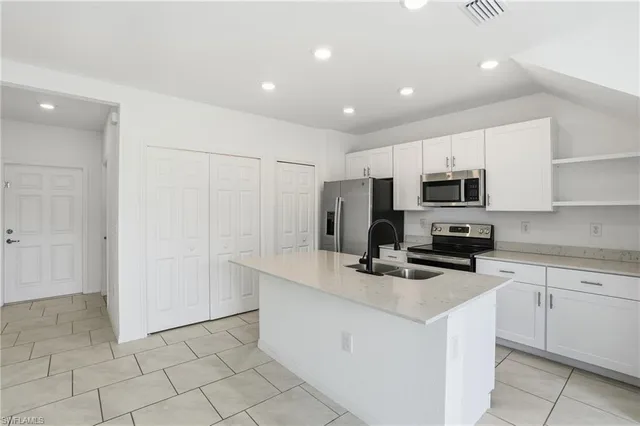 a view of kitchen with furniture and refrigerator