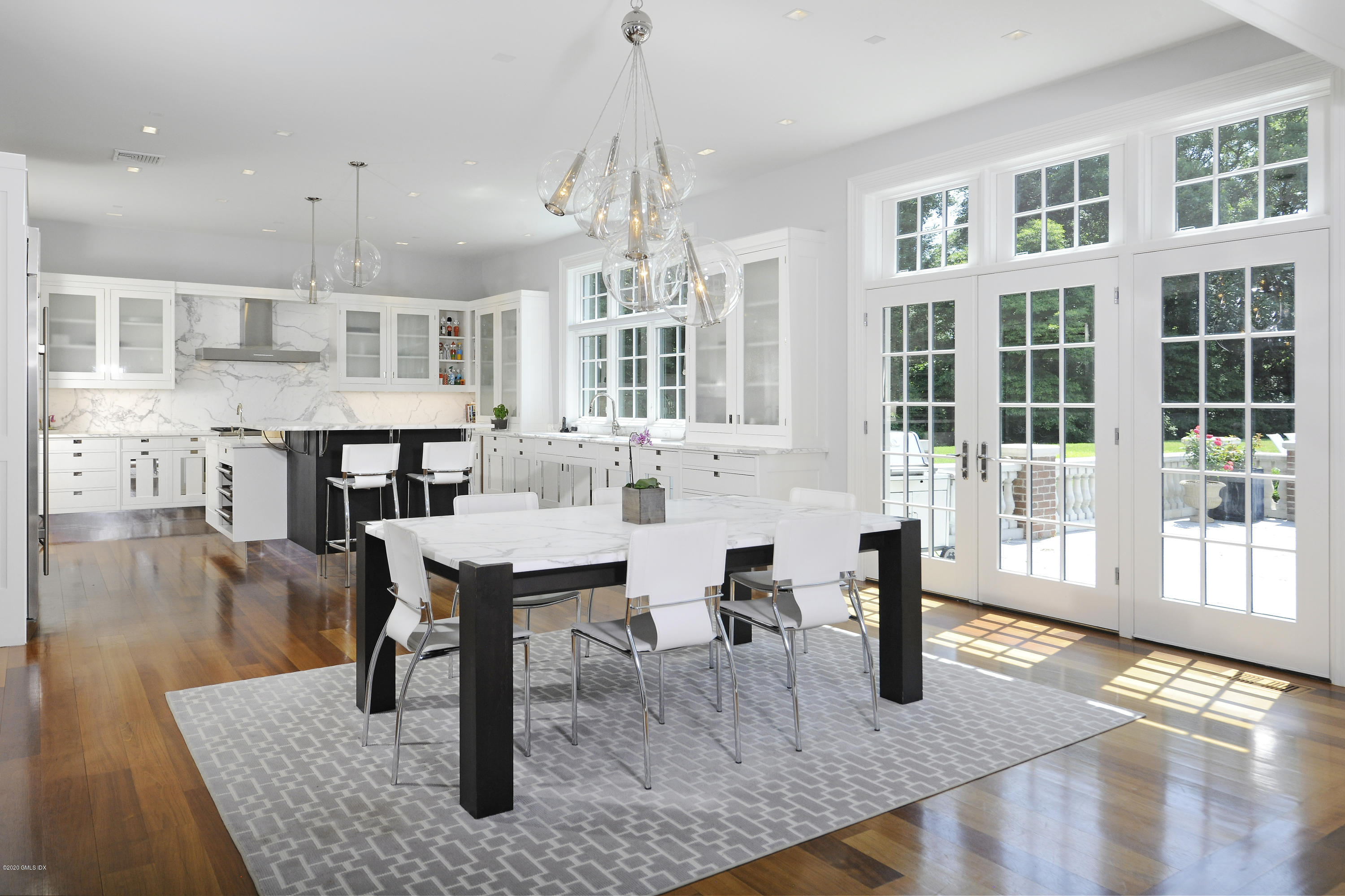 29 Doubling Road Greenwich, CT 06830 - Photo 13 of 26 a dining room with wooden floor and large windows