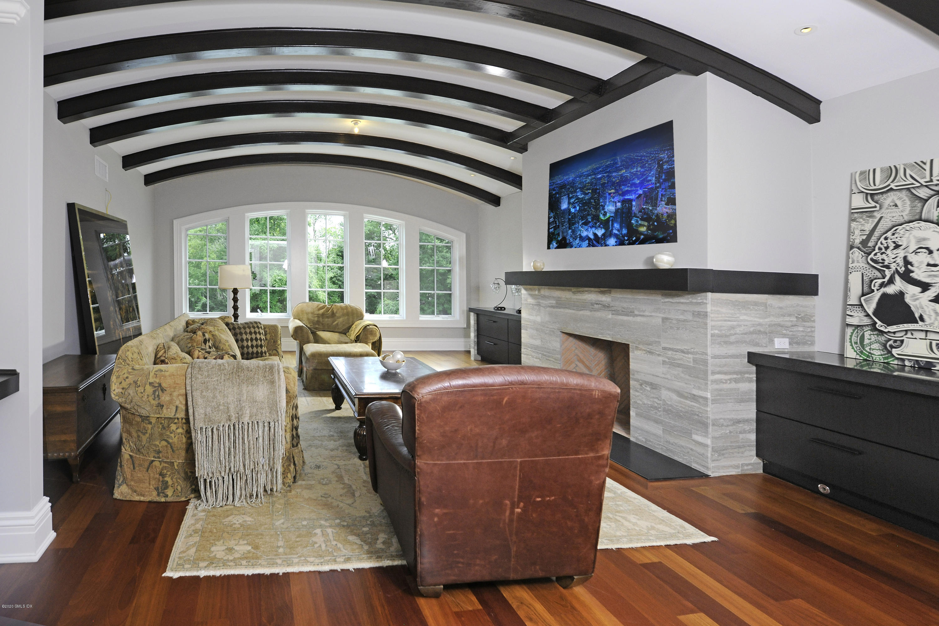 29 Doubling Road Greenwich, CT 06830 - Photo 20 of 26 a living room with furniture a fireplace and a floor to ceiling window