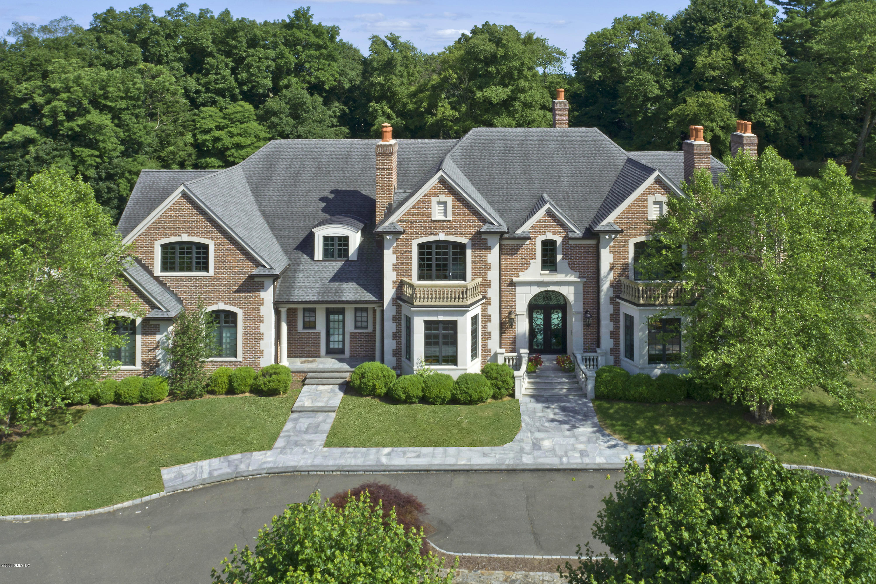 29 Doubling Road Greenwich, CT 06830 - Photo 2 of 26 a aerial view of a house next to a yard with big trees