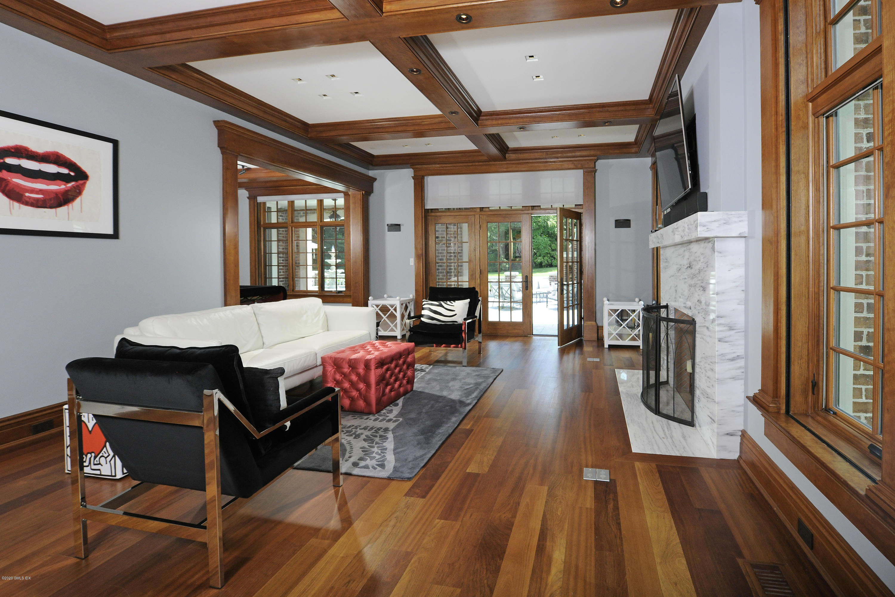 29 Doubling Road Greenwich, CT 06830 - Photo 8 of 26 a living room with furniture a wooden floor and a chandelier