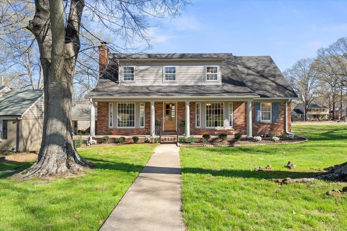 5600 Normandy Road Memphis, TN 38120 - Photo 1 of 28 View of front of home featuring brick siding, covered porch, a chimney, and a front yard