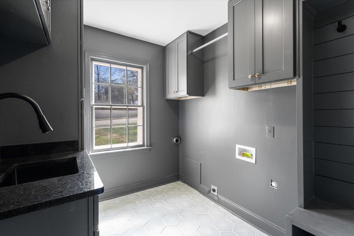 5600 Normandy Road Memphis, TN 38120 - Photo 16 of 28 Laundry area with a sink, baseboards, cabinet space, and washer hookup