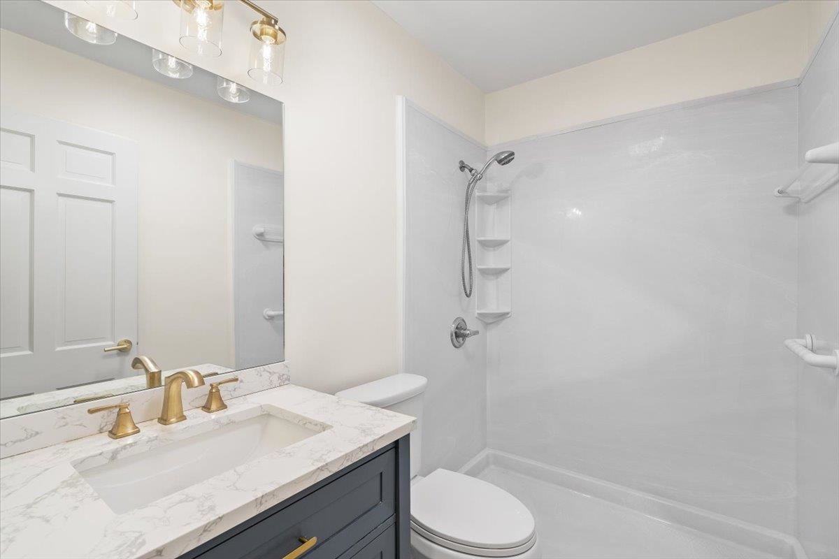 5600 Normandy Road Memphis, TN 38120 - Photo 17 of 28 Full bathroom featuring vanity, toilet, and a shower