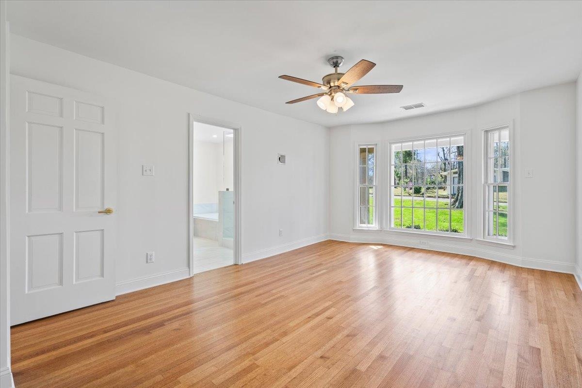 5600 Normandy Road Memphis, TN 38120 - Photo 18 of 28 Empty room featuring visible vents, baseboards, light wood finished floors, and ceiling fan