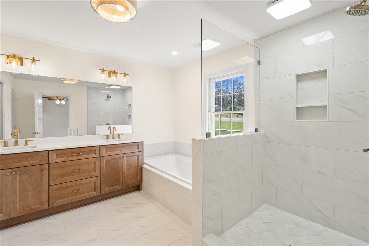 5600 Normandy Road Memphis, TN 38120 - Photo 19 of 28 Full bathroom featuring double vanity, a bath, a tile shower, and a sink