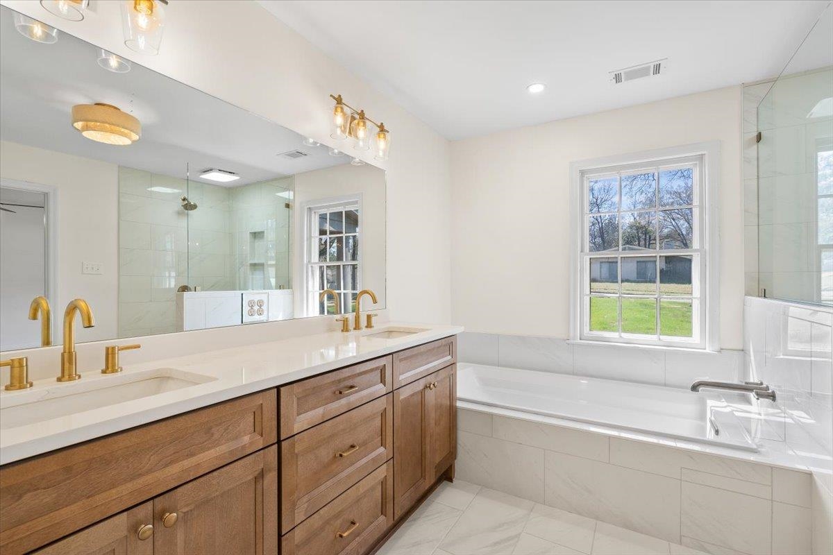 5600 Normandy Road Memphis, TN 38120 - Photo 20 of 28 Bathroom with a shower stall, a bath, double vanity, and a sink