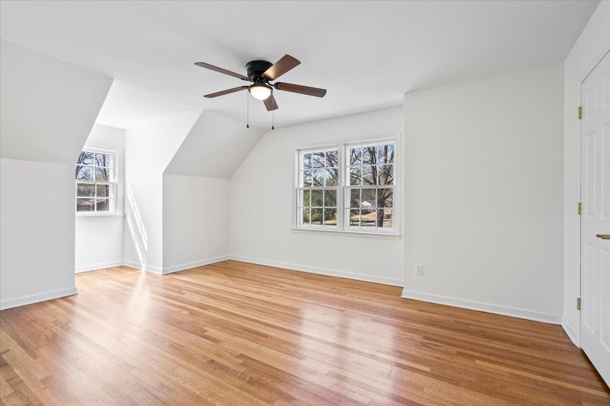 5600 Normandy Road Memphis, TN 38120 - Photo 22 of 28 Additional living space featuring baseboards, ceiling fan, vaulted ceiling, and light wood finished floors