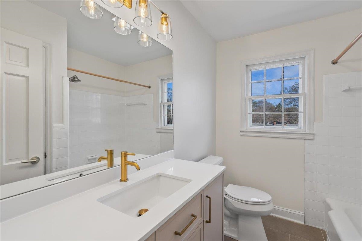 5600 Normandy Road Memphis, TN 38120 - Photo 24 of 28 Bathroom featuring tile patterned flooring, a chandelier, shower / washtub combination, toilet, and vanity